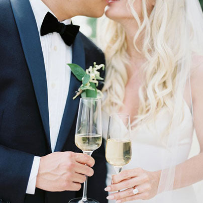 Bride and Groom kissing with champagne.